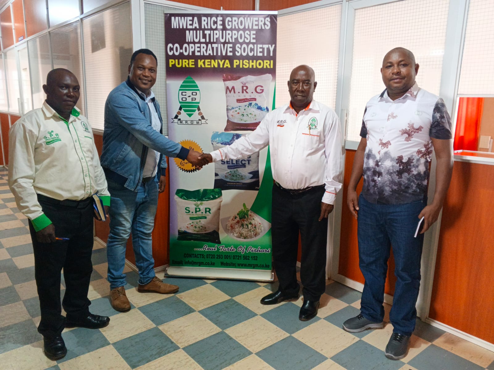 Handshake during stakeholder engagement at Mwea Rice Growers Multipurpose Co-operative Society